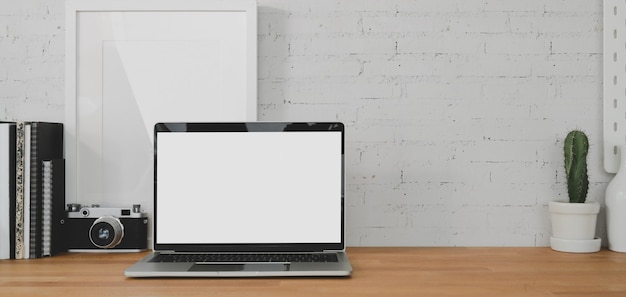 salle de bureau confortable avec ordinateur portable à écran blanc ouvert et fournitures de bureau