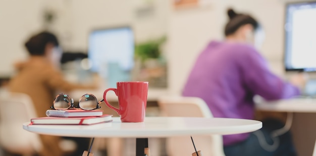 Photo salle de bureau moderne avec des verres et du café sur une table en bois blanche