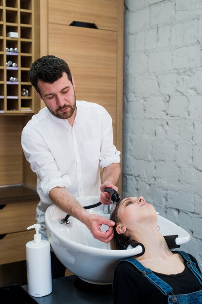 Salon de coiffure laver les cheveux de l'adolescente dans un salon de beauté.