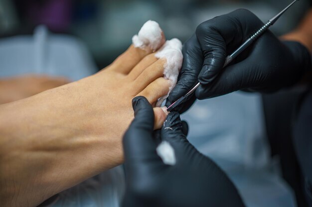 Photo salon de pédicure soins des pieds et des ongles traitement le processus de pédicure