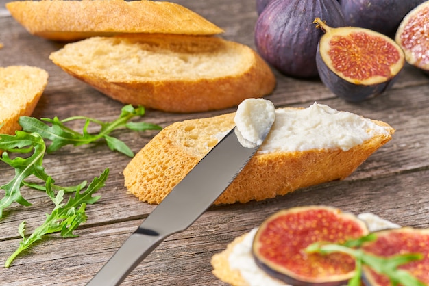 Sandwich au fromage à la crème, figues et miel sur une table en bois. Concept de nourriture saine.