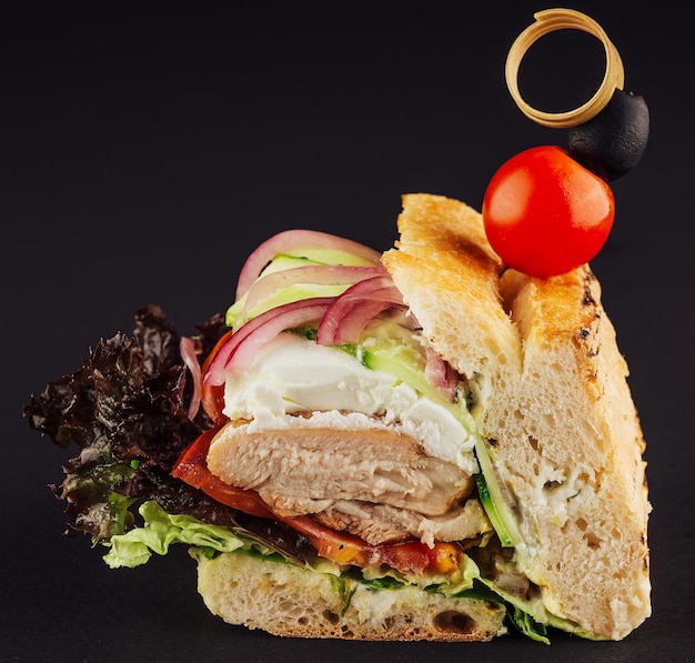 Sandwich au poulet grillé sain avec concombre tomate laitue et oignon