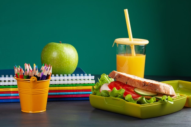 Photo sandwich frais et pomme pour un repas sain dans la boîte à lunch en plastique