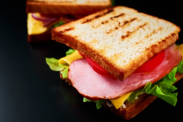 Sandwich maison avec laitue et jambon sur ardoise noire