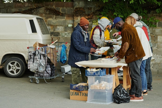 Les sans-abri reçoivent de la nourriture des bénévoles