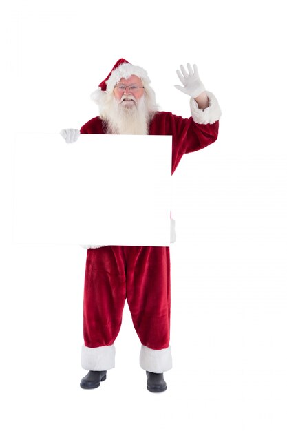 Santa tient un signe et fait signe