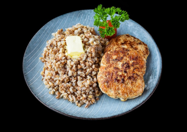 sarrasin avec escalopes de viande sur fond noir vue latérale