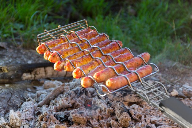 Saucisses frites sur un feu