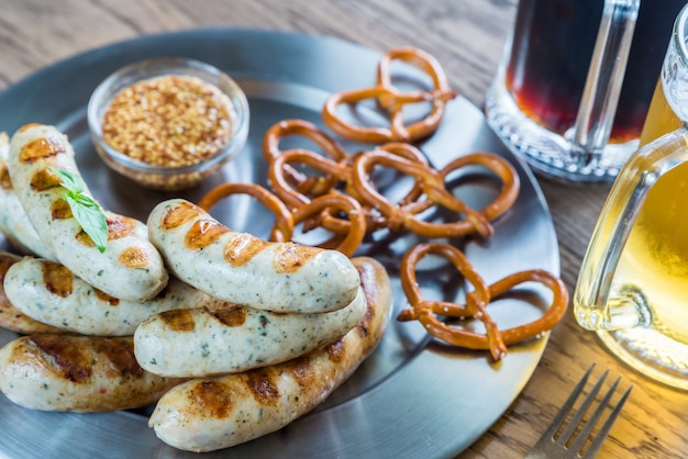 Saucisses grillées avec bretzels et chopes de bière