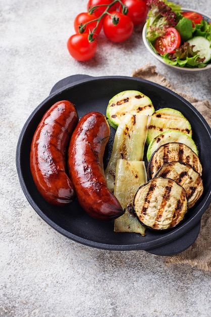 Saucisses de porc grillées et légumes