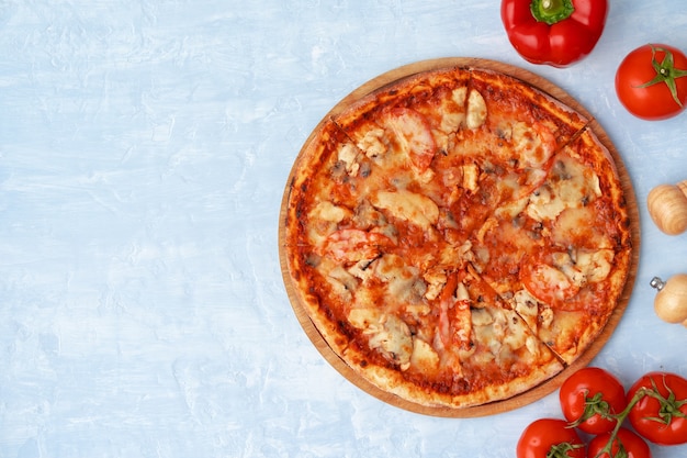 Savoureuse pizza au poulet et champignons, vue du dessus sur fond gris