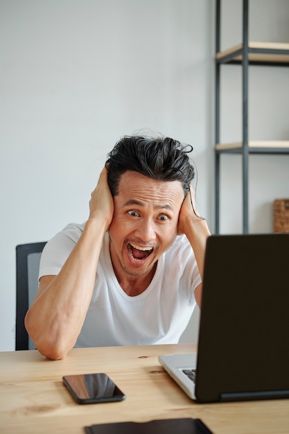 Schocked man reading e-mail