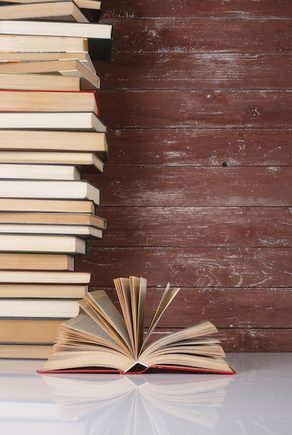 Science et éducation Livre ouvert sur une pile de livres de groupe et réflexion en bois