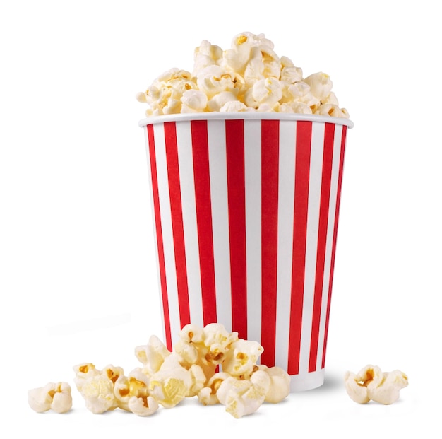 Un seau de pop-corn à rayures rouges et blanches est à côté de quelques pop-corn dispersés