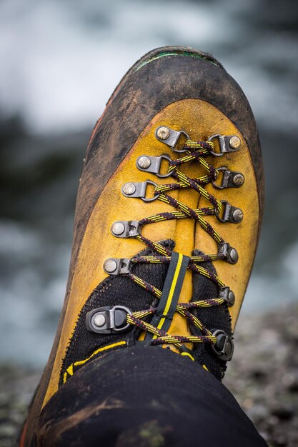 Photo section inférieure de la personne portant une chaussure de randonnée