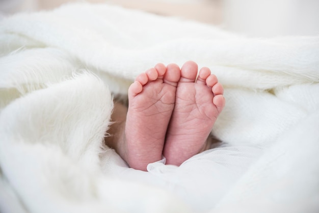 Section inférieure des pieds du bébé sur le lit