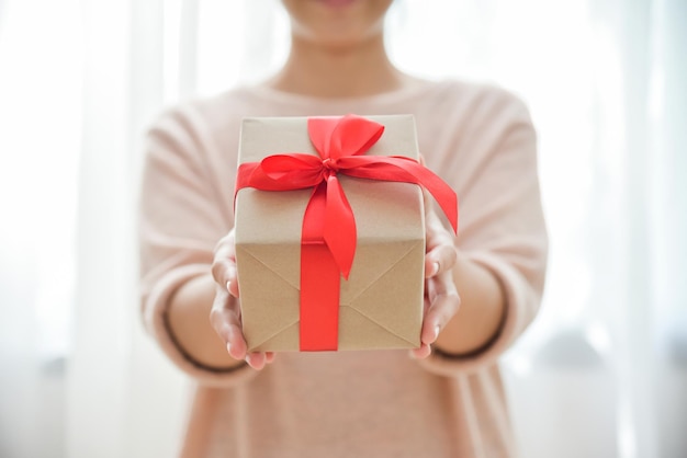 Section médiane d'une femme tenant une boîte à cadeaux