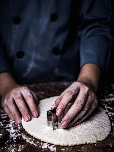 Section médiane d'une femme utilisant du métal en forme d'étoile sur de la pâte