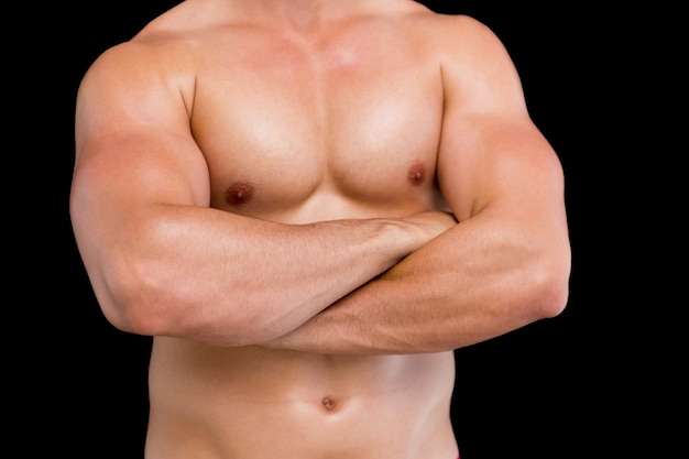 Section médiane d&#39;un homme musclé torse nu avec les bras croisés