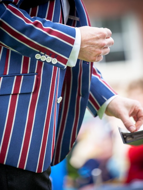 Photo section médiane d'un homme portant une veste bleue et rouge rayée