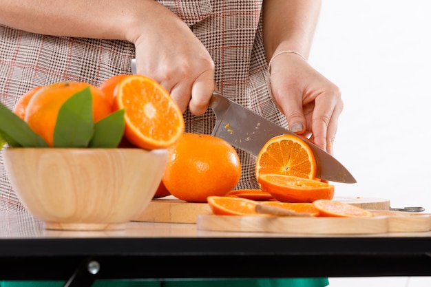 Section médiane d'un homme tenant un fruit d'orange sur la table