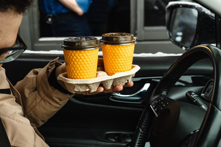 Photo section médiane d'un homme tenant de la nourriture dans une voiture