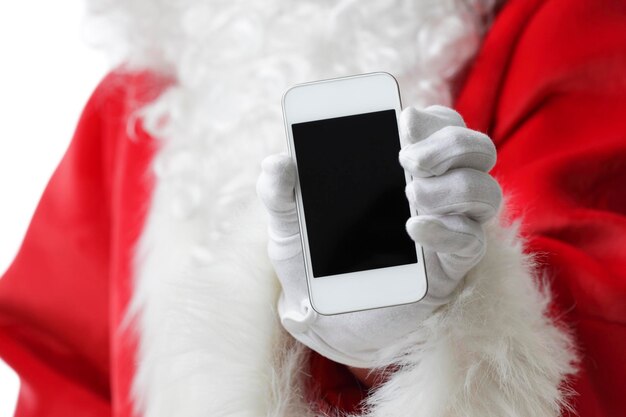 Section médiane d'une personne en costume de Père Noël tenant un téléphone portable sur un fond blanc
