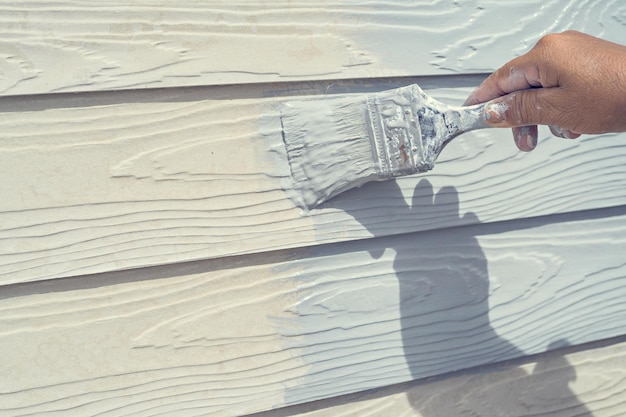 Section médiane d'une personne tenant une peinture sur le sol