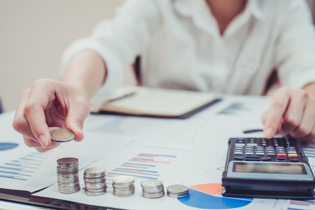 Section moyenne d'une femme d'affaires faisant des calculs à son bureau au bureau