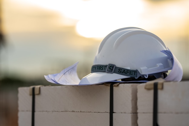 Sécurité du casque blanc et jaune dans la construction du site, concept de sécurité d'abord.