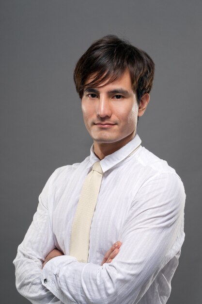 Séduisante Jeune Mec Asiatique En Costume Blanc, Portrait Agrandi Sur Fond Gris Studio.