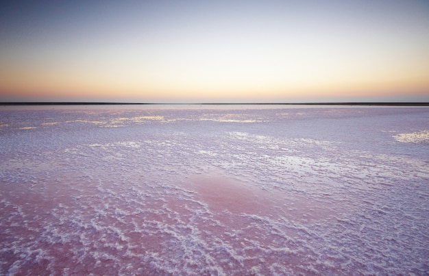Photo sel et saumure d'un lac rose, na au coucher du soleil