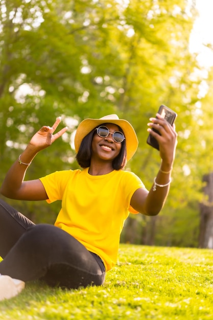 Photo selfie d'été jeune femme touriste noire profitant des bois avec un selfie