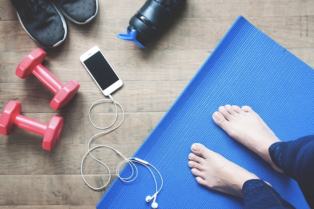 Selfie of feet yoga femme, smartphone, équipements sportifs et chaussures de sport sur le parquet