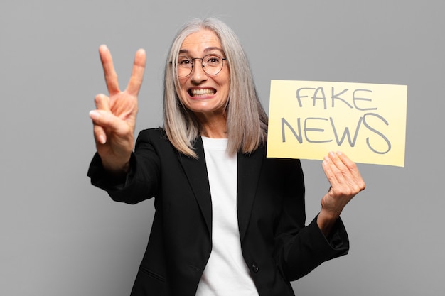 Senior businesswoman with fake news banner