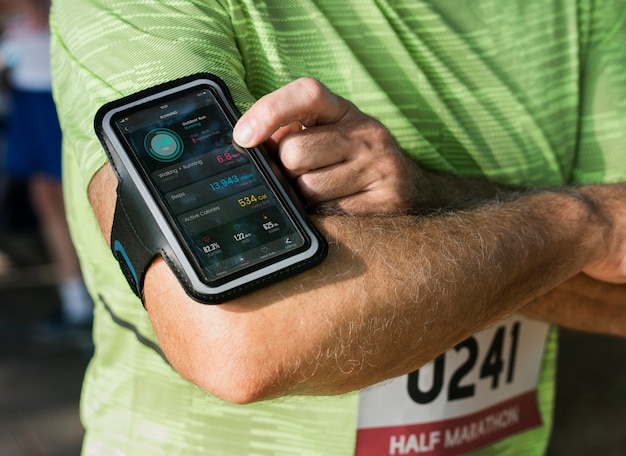 Senior coureur utilisant une application de suivi du fitness