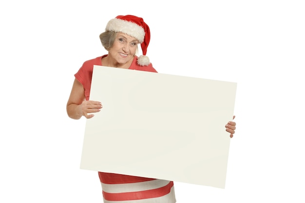 Senior woman in Santa Claus cap holding white blank