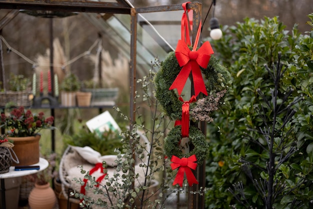 Serre décorée de couronnes et d'arcs rouges pour des vacances d'hiver