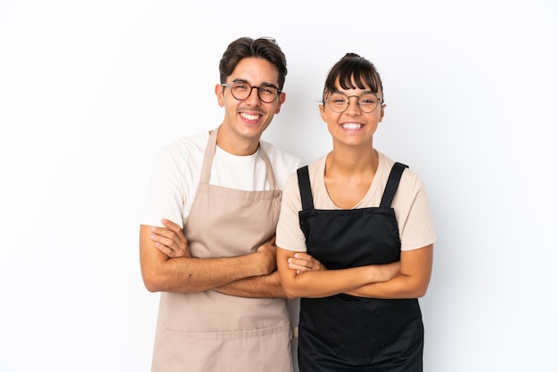 Serveurs de race mixte de restaurant isolés sur fond blanc en gardant les bras croisés tout en souriant