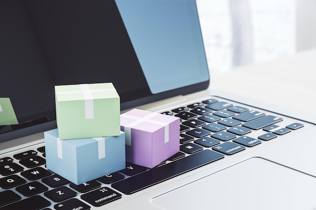 Service de messagerie et concept de livraison avec des boîtes colorées sur clavier d'ordinateur portable