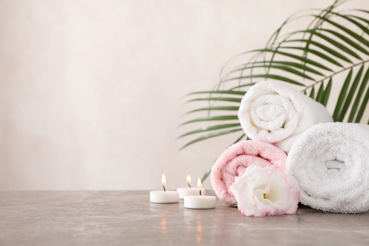 Photo serviettes, bougies et fleurs sur fond gris, espace pour le texte
