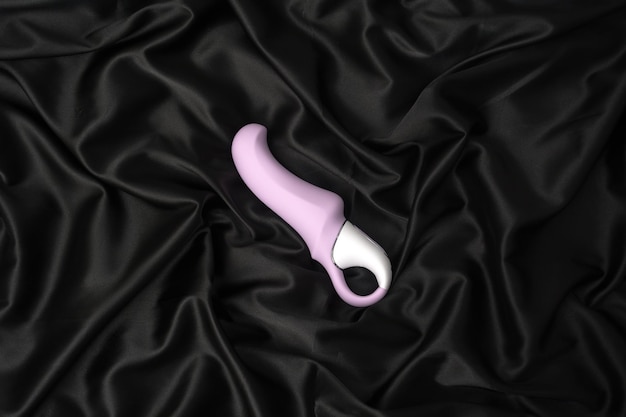 Photo sextoy violet sur fond de soie noire