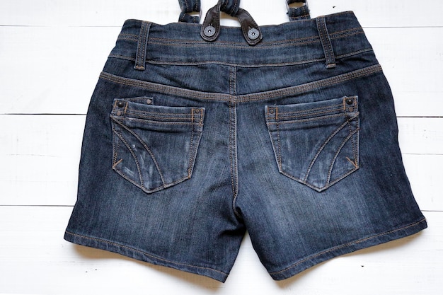 Short en jean avec bretelles sur fond blanc