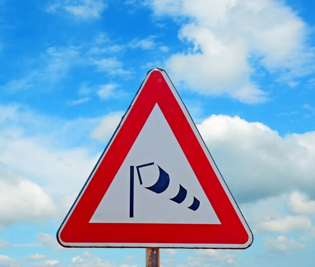 Signe de manche à vent sous un ciel bleu avec des nuages