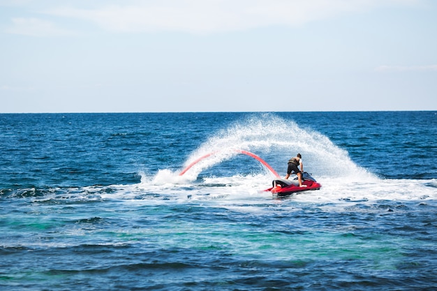 Silhouette d'un cavalier de fly board en mer