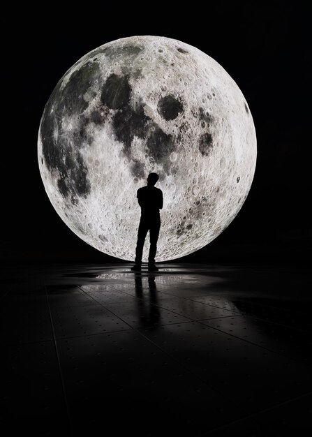 Silhouette d'un homme debout contre la lune la nuit