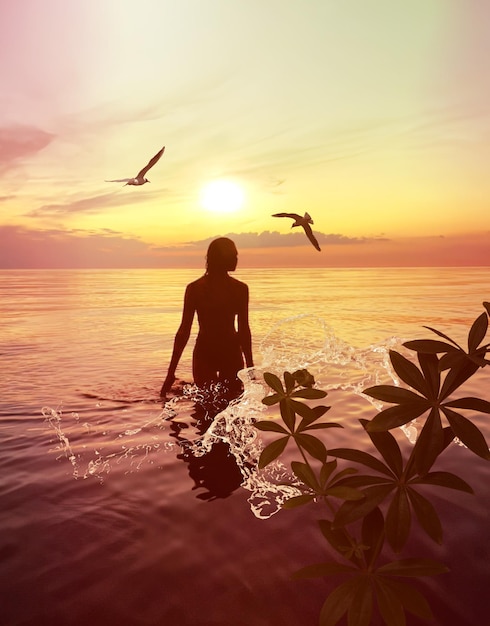 silhouette de jeune femme romantique au coucher du soleil orange dans la vague d'eau de mer et ciel nuageux rose