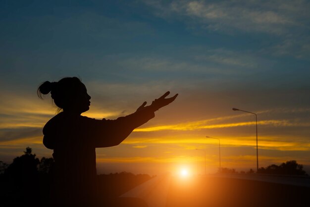 Silhouette de mains de femme avec la lumière du coucher du soleil