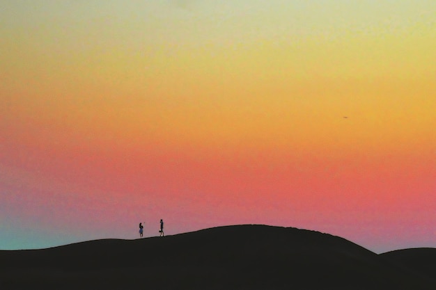 Photo silhouette de la montagne au coucher du soleil