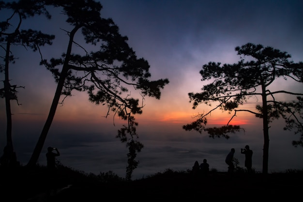 silhouette personnes lever du soleil sur la montagne.